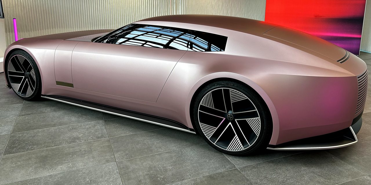 The same pink coupé after the wash: clean matte paint, clear glass and bright wheels